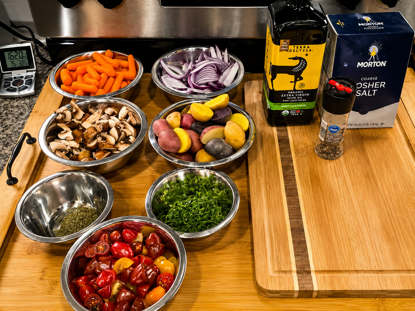 Mise en place for roasted chicken with vegetables herbs olive oil pepper and kosher salt
